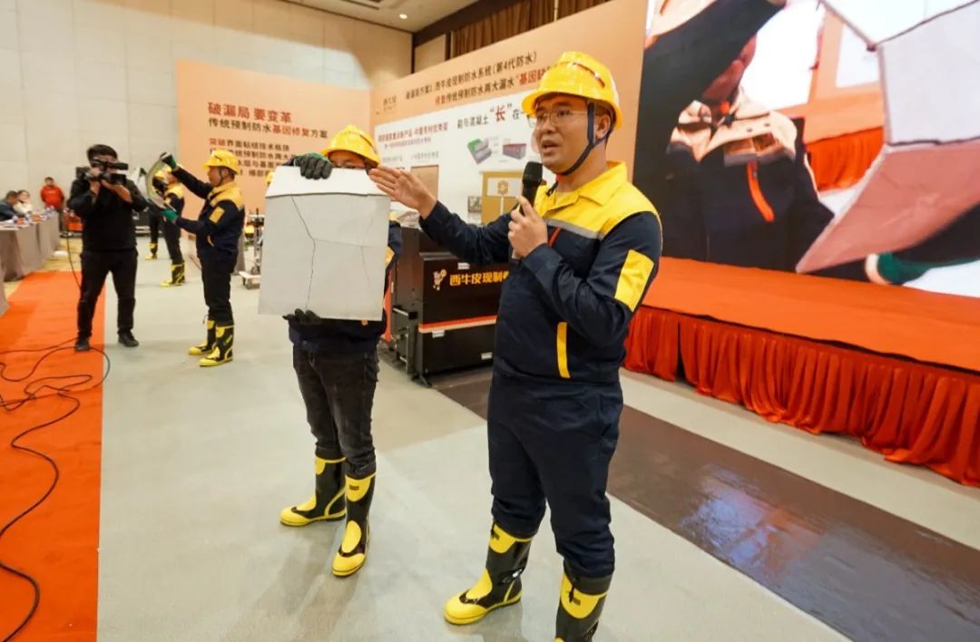 西牛皮中队队员向嘉宾们展示cps反应粘防水卷材与混凝土“骨肉相连”的粘连效果.jpg 图片关键词